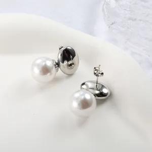 Detailed view of elegant pearl earrings with polished silver oval geometric metal plates