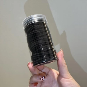 Black high-elasticity seamless hair ties set in a clear plastic storage bottle