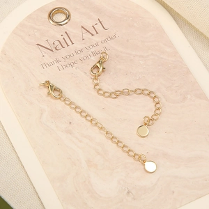 18k gold plated extension chain with lobster clasp and round tag on marble card
