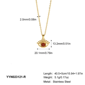 Detailed view of a gold stainless steel Evil Eye pendant with red bead inlay and chain