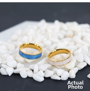 Detail of blue and white marble enamel inlay on gold-plated stainless steel rings