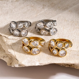 Detailed view of 18k gold and silver plated irregular rings with clear zircon on stone