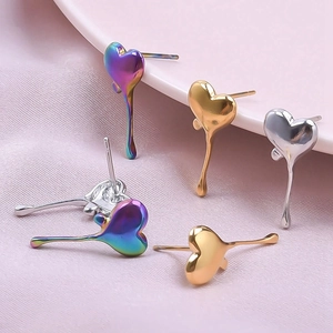 Macro detail of heart lava-style earrings in iridescent, gold, and silver finishes