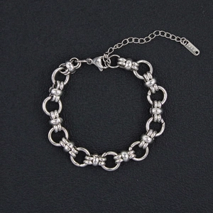 Detail of silver stainless steel chain bracelet with K18 engraving and lobster clasp