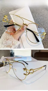 Detailed view of leopard head decor on golden aviator frames with anti-blue light lenses