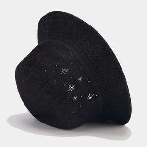 Detail of black denim bucket hat with decorative silver rhinestones in a star pattern