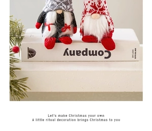 Charming plush Christmas gnomes sitting on books for a cozy holiday tabletop decoration