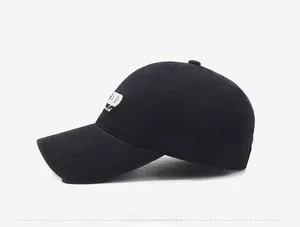 Side view of black cotton baseball cap with white 3D embroidery on the side