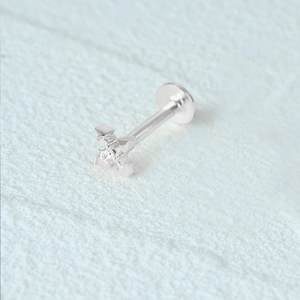 Detailed close-up of S925 silver cross stud earring with clear zircon inlay on white surface