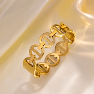 Bracciale rigido minimalista in acciaio al titanio dorato con maglie a catena intrecciate