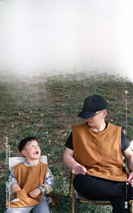 Detail of tan cotton-linen aprons for parents and kids with front pocket for art and BBQ