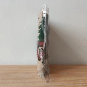 Christmas plaid chair cover with holiday motifs folded in transparent packaging