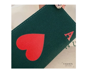 Detail of the stitching and Ace of Hearts print on a dark green canvas clutch bag