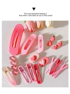 Detailed flat lay of pink Y2K hair clips set with heart shapes on a white background