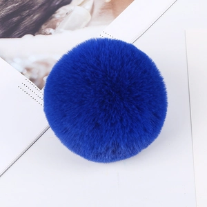 Macro shot of fluffy 8cm royal blue faux rabbit fur pom pom with soft texture detail