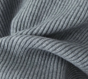 Macro shot of grey ribbed knit fabric texture showing premium soft wool material detail
