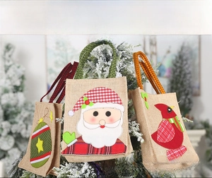 Rustic Christmas burlap gift bags with Santa and red bird appliques in snow scene