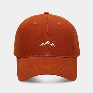 Detailed embroidery of white mountain peaks on a caramel outdoor baseball cap