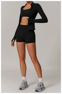 Detailed close-up of ribbed cuffs and thumbholes on a black seamless yoga jacket