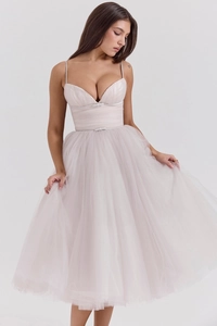 Detail of light pink mesh dress featuring a corset bodice and delicate waist bow tie