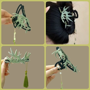 Detail of green bamboo leaf embroidered hair claw and tassel clip for high ponytail style