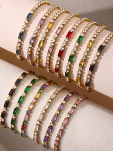 Detail of colorful rectangular zircon tennis bracelets on a white display roll