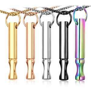 Detail view of colorful titanium steel meditation whistle pendants for mindfulness and yoga