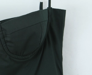 Close-up of sexy backless black dress with built-in cups and fine spaghetti straps