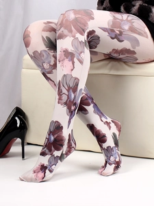 Detail view of floral printed tights showing purple and pink flower patterns on model legs
