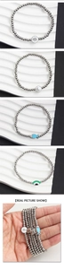 Detail view of 4mm stainless steel beaded bracelets with star, moon, and heart charms