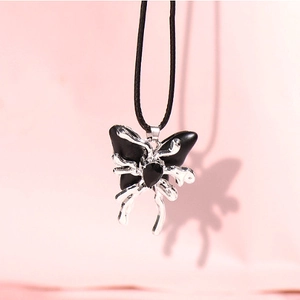 Liquid matte butterfly necklace with black and silver wings on a minimalist black cord