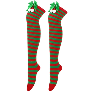 Detail of red and green striped Christmas over-knee socks with green bows and white pom-poms