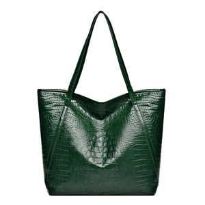 Dark green crocodile texture tote bag with long shoulder straps on white background