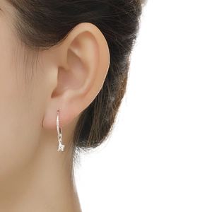 Detail view of a model wearing a polished S999 sterling silver star drop earring