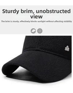 Detail of a structured black winter baseball cap with a silver crown metal emblem