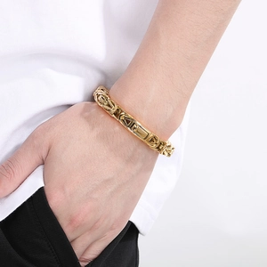 Close-up of a gold-toned punk style square chain bracelet worn by a male model