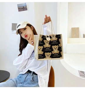 Detail of printed canvas lunch bag with cute bear and rope handles in a lifestyle setting