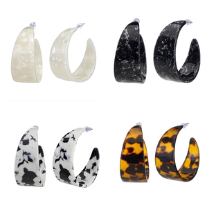C-shaped acetate resin earrings set in marble, cow print, and tortoiseshell patterns