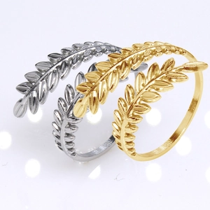 Detailed macro of gold and silver stainless steel adjustable rings with leaf pattern