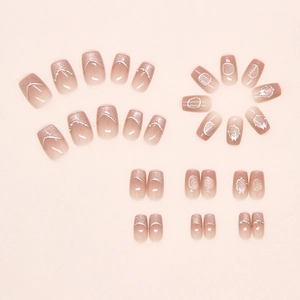 Detail of pink cat eye press-on nails with 3D butterfly and pearl accents