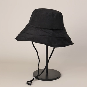 Detailed view of a professional black quick-dry bucket hat with wide brim and chin strap