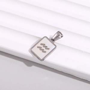 Macro detail of square stainless steel necklace featuring a white shell Aquarius pendant