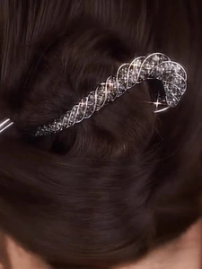 Close-up of sparkling rhinestone twist hair pin styled in a dark brown bun