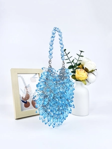 Macro shot of blue handmade acrylic beaded handbag with textured teardrop beads