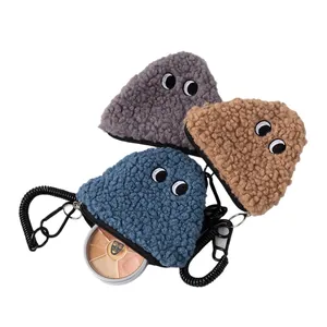 Three triangular plush rice ball coin purses in grey, brown, and blue with elastic cords