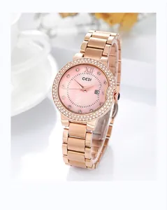 Close-up of rose gold watch featuring a diamond bezel and pink mother of pearl dial