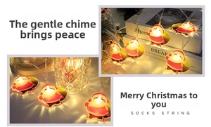 Detail of warm white LED Christmas string lights with cute Santa Claus figures