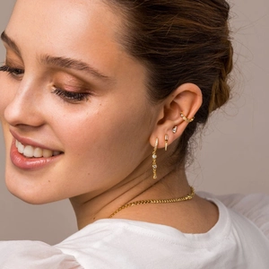 Close-up of golden S925 sterling silver chain drop earrings with sparkling cubic zirconia