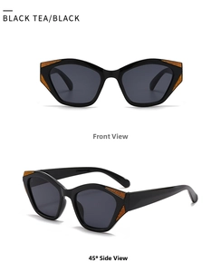Close-up of black cat-eye sunglasses with orange textured detailing on the frame edges