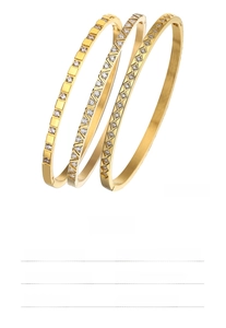 Detail view of 4mm titanium steel bangles with diamond-set geometric patterns in gold finish